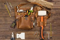 the tools are laid out on the wooden table to be used as a tool bag