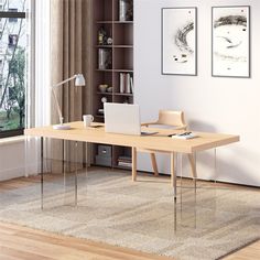 a desk with a laptop on it in front of a bookcase and window overlooking a yard