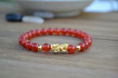 "This is Pure Real 24 Karat Gold Pixiu/Natural Carnelian Gold Pixiu Piyao( less than 1 g ) - Approximately 13mm x 6mm 14 karat Gold Beads Round - Approximately 3mm Carnelian Beads - Approximately 6mm Hallmark/Stamp 999 for 24k Gold (PIXIU) Please select bracelet size. All are handmade with care .Strung on heavy duty stretchy/elastic. Products and photo may differ. Bracelet Comes with Storage Bag & Box How to Determine Bracelet Size: Step 1: Measure your wrist just below the wrist bone, where Hand-strung Carnelian Bracelets Gift, Hand-strung Carnelian Bracelet As Gift, Red Carnelian Bracelets With 8mm Beads, Red Carnelian Beaded Bracelets For Gift, Red Carnelian Bracelets As Gift, Red Carnelian Bracelets As A Gift, Red Agate Bracelets For Meditation, Red Carnelian Bracelets For Gifts, Spiritual Red Agate Bracelets