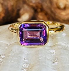 This classic east west bezel setting contains a beautiful 3.00ct natural emerald cut amethyst. The emerald cut stone measures approximately 10x8mm. The ring is available in a satin or high polish finish. The ring is available in sterling silver, and 14k white, yellow, or rose gold. Amethyst is the birthstone for February. Please send me a message if you need a size not listed. * This ring can be customized with any color center stone. All items are handmade by me in my shop in Woodbridge, NJ. Pl Original Engagement Rings, Emerald Cut Ring, Gold Amethyst Ring, Ring Emerald Cut, Emerald Cut Rings, Bezel Ring, Ring Emerald, Amethyst Gem, Amethyst Gold