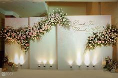 the wedding stage is decorated with flowers and candles