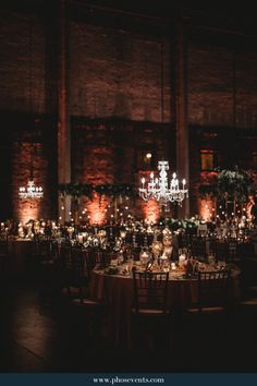 the tables are set with candles and centerpieces for an elegant wedding reception at night