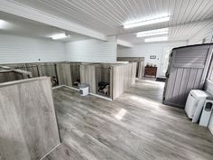 an empty kitchen with wood floors and white walls is seen in this image from the inside