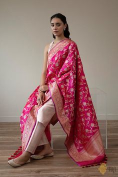 "This ravishing Banarasi dupatta is destined to become a family heirloom. A luxurious full-kadwa floral jaal which brings with it the best of Indian weaving heritage. A real trousseau treasure.\n\u00a0\n\n\n\n Color\u00a0-\u00a0A stunning shot colour with a warp of Red and a weft of Rani Pink\n\n Technique\u00a0-\u00a0An enduring Kadwa weave. The elaborate and laborious Kadwa (Kadhua) technique involves hand-weaving each motif separately. It takes longer on the handloom, but makes a more robust pattern, which stands out on the fabric.\u00a0\n\n Fabric\u00a0- Soft as butter, pure Katan silk\n\n Speciality\u00a0- \u00a0Luxury is in the details. This is a painstakingly handwoven dupatta with a rich and intricate weave in gold and silver zari in breathtaking Banarasi opulence.\n\n Tilfi Promis Luxury Handloom Dupatta For Rituals, Luxury Handloom Cotton Silk Dupatta, Luxury Katan Silk Block Print Dupatta, Cheap Festive Katan Silk Dupatta, Luxury Silk Dupatta With Zari Weaving, Cheap Unstitched Katan Silk Traditional Wear, Rani Pink, Katan Silk, Family Heirloom