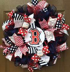 a red white and blue baseball wreath with the number 8 on it's front door