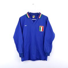 Nos Vtg 80s Mens Medium Italy Italia World Cup Patch Long Sleeve Soccer Jersey Mens T-Shirt New Vintage Never Worn Without Tags. Some Discoloration On The Collar Due To Storage/Age Mens Size Medium Measurements Are: 20 Inches Underarm To Underarm 27 Inches Top To Bottom Blue 63% Nylon 37% Cotton Check Out My Other Items In My Store! Sb2 Vintage Blue Crew Neck Shirt, Retro Blue Long Sleeve Shirt, Retro Long Sleeve Blue Shirt, Blue Retro Long Sleeve Shirt, Italia Jersey, Soccer Supplies, Long Sleeve Soccer Jersey, Vintage Soccer Jersey, Italy Soccer