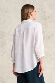 This 100% French linen shirt with natural shell buttons and elasticated cuffs is a light and breathable addition to any outfit. As well as classic shirt details, it features intricate picot detailing along the pocket and hem. Available in White, this shirt pairs perfectly with our signature Bengajean®. Classic White Blouse With Roll-up Sleeves, Elegant Linen Tops With Buttons, Classic Blouse With Shirttail Hem For Casual Gatherings, White Linen Shirt With Button Cuffs, Linen Shirt With Button Cuffs For Daywear, Classic Linen Blouse With Buttons, Classic Linen Tops With Fold Down Collar, Casual Shirttail Hem Top With Button Cuffs, Linen Button-up Shirt With Roll-up Sleeves