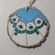 a wooden ornament with three polar bears on it