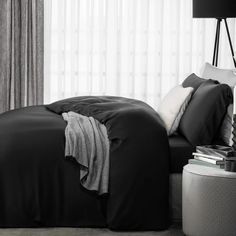 a black and white photo of a bed in a bedroom