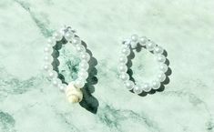 This cute Pearl ring set is so cute and you get two pearl rings one with shells and one plain! For more pearl vibes buy the pearl bracelet and ring set! Bracelet And Ring Set, Bracelet And Ring, Pearl Rings, The Pearl, Pearl Ring, Pearl Bracelet, Ring Set, Ring Sets, Jewelry Bracelets