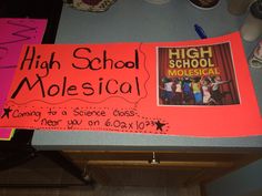 a high school musical sign is posted on the back of a bulletin board with writing