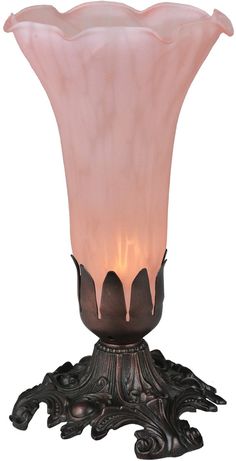 a pink glass vase sitting on top of a metal stand with a light in it