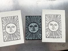 three sun and moon drawings on white paper