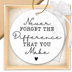 a white ornament with the words never forget the difference that you make