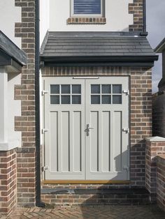 a white garage door on a brick house