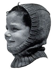 a black and white photo of a young boy wearing a knitted hood over his head