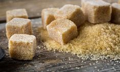 some sugar cubes are on a wooden table