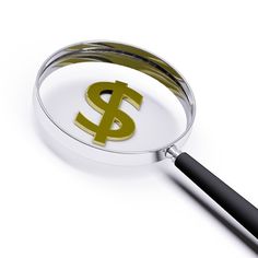 a magnifying glass with a gold dollar sign on the side and black handle