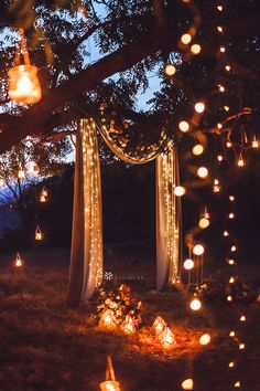 an outdoor ceremony with candles and lights