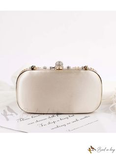 a white purse sitting on top of a table