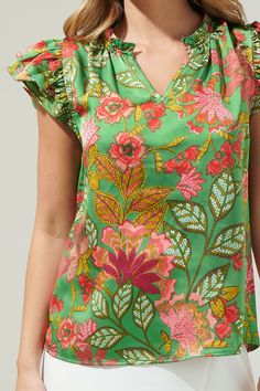 The Susy Paradise Bellissima Ruffle Sleeve Top will make you want another vacation with it’s tropical green and pink satin print. It has a highlighting silhouette followed by a split neckline and ruffle cap sleeves. The bodice maintains a classic fit that can easily be styled tucked into a pair of high waisted shorts and loafers for a classic look.- Cap sleeves- Split - Ruffle layers - Relaxed fit- Color: Green MultSize + Fit - Model is 5'8" and wearing size XS- Measurements taken from size S - Ruffled Sleeve Top, Pink Satin, High Waisted Shorts, Classic Looks, Cap Sleeves, Sleeve Top, Bodice, Fitness Models, High Waisted