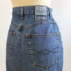 Vintage 90s classic jeans mini skirt for casual trendy women. This pencil jeans skirt is slim fit and high waist, it has side pockets. The minimal style denim skirt is very comfy for total looks. The skirt is cotton fabric, by Pamir Jeans, and it's excellent vintage conditions The estimated modern size is M/L, depending on waist contour fit 29,9 inch. (76 cm) ** MEASURES FLAT ** Waist 14,9 in // 38 cm Hip 19,6 in // 50 cm Length 21,6 in // 55 cm Reference: Model size S (4/6 US - height 65 in) Re Classic Mid-rise Denim Blue Denim Skirt, Classic Mid-rise Denim Blue Skirt, Classic Fitted Mid-rise Denim Skirt, Fitted High Rise Classic Denim Skirt, Classic Straight Leg Denim Skirt With Pockets, Classic Fitted High Rise Denim Skirt, Classic Fitted High-rise Denim Skirt, Classic High Rise Dark Wash Denim Skirt, Classic Denim Blue Denim Skirt With Pockets