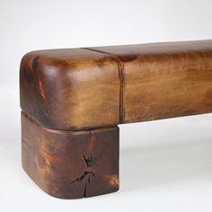 a bench made out of wood and leather