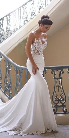 a woman in a white wedding dress is standing on the stairs with her hand on her hip