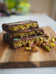 three chocolate bars stacked on top of each other with nuts and pistachios