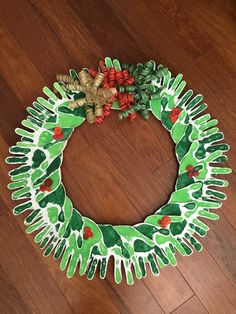 a christmas wreath made out of green and red paper