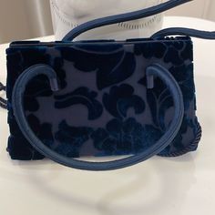 Vintage Early 2000’s Bloomingdale’s Own Tone On Tone Navy Blue Velvet Floral Pattern On Navy Blue Silk Like Fabric. Can Be Used As Hand Held Or Shoulder. Fabric Double Handles Single Navy Rope Shoulder Strap. Footed Bottom Protects This Delicate And Feminine Bag. Snap Top Closure. New W/O Tags. Never Used. Vintage! Designer Blue Box Bag With Removable Pouch, Designer Blue Box Shoulder Bag, Designer Blue Top Handle Box Bag, Designer Blue Box Bag With Top Handle, Designer Blue Bag With Top Carry Handle, Designer Blue Tote Box Bag, Designer Blue Box Bag With Detachable Handle, Designer Blue Handheld Satchel, Designer Navy Rectangular Bags