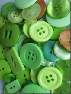 several green and white buttons sitting on top of each other