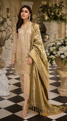 Pakistani embroidered organza dress in dark skin color with eye catching embroidery.Pakistani embroidered organza dress is embellished net style embroidered organza shirt. Overall dress is designed with gold skin thread embroidery. Sleeves and bottom has beautiful thread work. Neckline has also embroidered patti. Trouser: Raw silk trouser in matching color is added your fancy look for party or wedding embellished with net embroidered trouser patti at bottom. Dupatta: Embroidered Organza Jacquard Embroidered Organza Dress, Organza Dresses, Pakistani Traditional, Pakistani Designer Clothes, Fancy Clothes, Pakistani Fashion Party Wear, Salwar Kamiz, Desi Clothes, Chiffon Collection