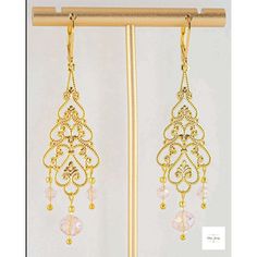 You will look so pretty in these Pink Glass Filigree Drop Earrings! Enhance your beauty with these Pink Glass Filigree Earrings! Sweet and elegant these stunning earrings are a must-have for any wardrobe, featuring lovely faceted pink briolette glass beads, micro-faceted white glass beads, and gold seed beads. The gold-plated filigree and lever backs add a touch of elegance to these 2.75 inch long earrings. Perfect for adding a touch of romance and charm to your look, these gold filigree dangle Gold Delicate Crystal Earrings For Party, Delicate Gold Crystal Earrings For Party, Delicate Gold Crystal Party Earrings, Gold Beaded Chandelier Earrings For Gift, Delicate Gold Beaded Earrings, Elegant Earrings With Gold Beads, Elegant Rose Gold Beaded Dangle Earrings, Elegant Gold Beaded Chandelier Earrings As Gift, Elegant Pink Beaded Earrings For Gift