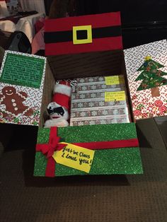 an open christmas gift box sitting on top of a table