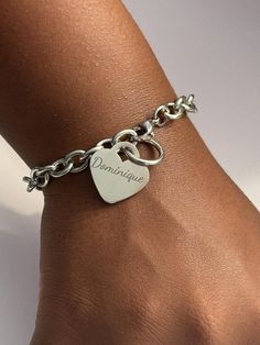 Delight in the timeless elegance of the Personalized Stainless Steel Heart Bracelet, a perfect accessory for any occasion. Constructed from 316L Surgical Grade Stainless Steel, this bracelet is designed to withstand daily wear without tarnishing or causing skin discoloration. It is water-resistant, making it ideal for wearing in the shower or pool. Available in 7-inch and 8-inch lengths and measuring 1/4 inch wide (7mm), it ensures a comfortable fit for everyone. Features: Material: Made from 316L Surgical Grade Stainless Steel that won't tarnish or turn skin green, ensuring long-lasting wear and durability. Lengths: Available in 7-inch and 8-inch lengths to provide a perfect fit for every wrist. Width: The bracelet measures 1/4 inch wide (7mm), offering a sleek and elegant look. Heart Cha Elegant Engraved Stainless Steel Bracelets, Elegant Stainless Steel Engraved Bracelets, Elegant Engraved Stainless Steel Bracelet, Everyday Metal Bracelets For Valentine's Day, Everyday Stainless Steel Bracelet With Heart Charm, Personalized Metal Heart Bracelets, Classic Metal Bracelets For Gifts, Trendy Silver Bracelet For Wedding, Trendy Silver Wedding Bracelet