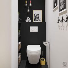 a white toilet sitting inside of a bathroom next to a black and white wall with pictures on it