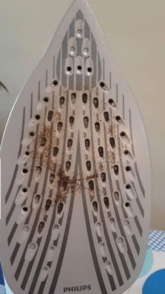 a close up of a metal grater on a table with blue circles and polka dots