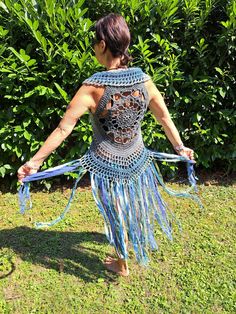 crocheted FESTIVAL VEST size XS-M Fantastic crochet vest with a floral pattern on the back and ties for lacing on the front - therefore adjustable and stretchable from XS-M (32-40), crocheted with love from soft cotton yarn.  Decorated with many long fringes made of different wool, effect yarns, fabrics and lace, which come into their own when walking, dancing and turning. The waistcoat can easily be machine washed at 30oC (possibly gather the fringes with a rubber band beforehand so that they d Blue Sleeveless Vest For Festival, Bohemian Fitted Sleeveless Vest, Fitted Bohemian Sleeveless Vest, Sleeveless Stretch Crochet Top For Festivals, Fitted Bohemian Crochet Vest Top, Bohemian Fitted Vest For Beach, Fitted Sleeveless Crochet Top For Festival, Hippie Style Fitted Sleeveless Vest, Fitted Sleeveless Hippie Vest