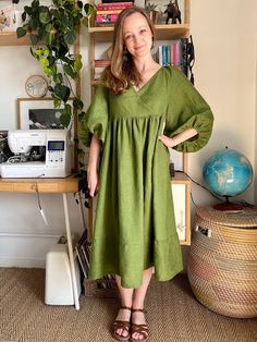 a woman standing in front of a bookshelf