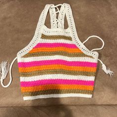 a knitted striped tank top sitting on a couch