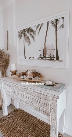 a white table with plates and bowls on it in front of a palm tree print