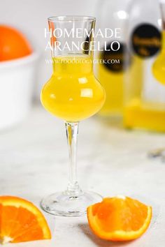 an orange juice in a wine glass on a table