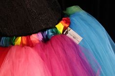 "Perfect tutu for Pride! This tulle tutu skirt Can also be used for carnivals, weddings, costumes, clowns, or anything rainbow themed! This tutu design is extra fluffy! This rainbow tutu design is Handmade from 50yards, two layers of gathered panels of soft smooth red, orange, yellow, mint, green, turquoise, purple, fuchsia and hot pink Bridal tulle. All tulle panels have been tightly machine gathered and serged to the soft rainbow fabric covered elastic waistband. This tutu is fully sewn not ti Multicolor Tulle Tutu Dress For Costume Party, Fun Fitted Tutu Dress For Party, Fitted Multicolor Tutu Dress For Fun, Spring Costume Tulle Tutu Dress, Fun Fitted Multicolor Tutu Dress, Spring Tulle Tutu Dress For Costume, Fitted Multicolor Tutu Dress, Fitted Tutu Dress For Carnival Costume Party, Fitted Tutu Dress For Costume Party And Carnival