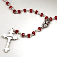 Dimensions: H 22.4" Description: Made of magnificent red coral, this rosary is skillfully hand carved by Christian craftsmen to create a beautiful and a classic piece for Christians around the world. Works as a perfect first communion gift or for personal use, this exquisite rosary will be a constant reminder of the serenity of the Holy Spirit, and the importance of praying to Virgin Mary of is always watching over us. The centerpiece for this gorgeous Bethlehem Rosary is Virgin Mary with Jesus Red Beaded Rosary For Spiritual Use, Crucifix Jewelry With Faceted Beads For Gift, Crucifix Jewelry With Faceted Beads As Gift, Crucifix Shaped Jewelry With Faceted Beads As Gift, Adjustable Red Rosary With 8mm Beads, Spiritual Red Crucifix Rosary, Handmade Red Crucifix Jewelry, Red Spiritual Rosary As Gift, Red Spiritual Cross Pendant Jewelry