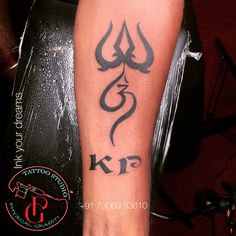 a man with a tattoo on his arm has a snake and letter k in it