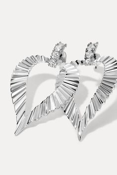 Inspired by statement jewelry from the 1980s, the Jasmine Earrings are sure to turn heads with every wear. Unapologetically bold and undeniably cool, they feature embellished studs and a striking textured heart. Sterling silver-plated 59mm height, 33mm width Includes earring backs Glamorous Silver Heart Earrings For Anniversary, Sterling Silver Pierced Heart Earrings For Party, Silver Heart Pierced Earrings For Party, Silver Heart Drop Earrings, Glamorous, Glamorous Silver Heart Earrings For Party, Glamorous Heart Earrings For Party, Glamorous Heart-shaped Evening Earrings, Glamorous Evening Heart Earrings, Glamorous Heart Shaped Evening Earrings