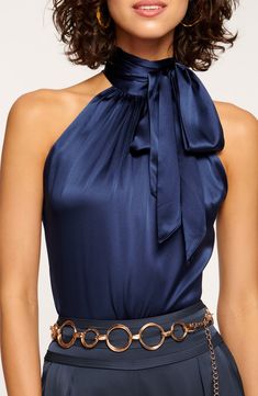 Rich stretch silk elevates this versatile top featuring a dramatic high neck with a lavish bow in back for an extra touch of glam. 26" center front length (size Medium) Back keyhole with tie closure High halter neck Sleeveless, with cutaway shoulders 92% silk, 8% spandex Dry clean Imported Individualist Luxury Silk Tops, Luxury Chic Zara Blouse, Luxury Art Silk Blouse With Self Design, Luxury Glamorous Halter Top, Silk Tops Blouses Classy, Wide Neck Blouses, High Neck Blouse With Jewelry, Luxury Elegant Tops, Luxury Designer Tops