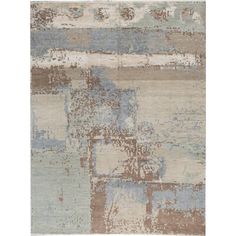 an area rug with various colors and shapes on it, including blue, brown, beige and white