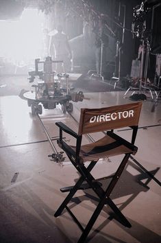 a director's chair sits in the middle of a stage